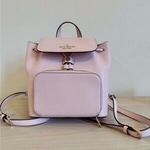 Kate Spade lite pink small size backpack. Zipper and wallet enclosures.